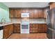 Well-equipped kitchen boasting wood cabinets and stainless steel appliances at 8 Escondido Cir # 78, Altamonte Springs, FL 32701