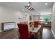 Elegant dining room with chandelier and view into living room at 30215 Bretton Loop, Mount Dora, FL 32757