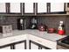 Modern kitchen with gray cabinets and gray tile backsplash at 4546 Narrative Ln, Kissimmee, FL 34746