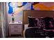 Bedroom with a white nightstand, mural, and themed bedding at 4546 Narrative Ln, Kissimmee, FL 34746