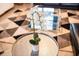 White orchids in a pot displayed on a round silver coffee table at 4546 Narrative Ln, Kissimmee, FL 34746