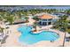 Large, freeform community pool with plenty of lounge chairs at 4546 Narrative Ln, Kissimmee, FL 34746