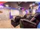 Home theater with large screen, comfortable seating, and a galactic mural at 4546 Narrative Ln, Kissimmee, FL 34746