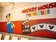 Mickey Mouse Funhouse themed wall mural in a bedroom at 4546 Narrative Ln, Kissimmee, FL 34746