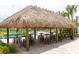 Relaxing tiki hut with tables and chairs near the pool at 4546 Narrative Ln, Kissimmee, FL 34746