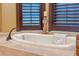 Relaxing bathtub with window views and a cozy atmosphere at 11954 Provincial Way, Windermere, FL 34786