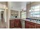 Kitchen with wood cabinets, a breakfast bar, and a view of the backyard at 3202 Misty Morn Ct, St Cloud, FL 34771