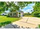 Brick home with green shutters, double garage, and manicured lawn at 3202 Misty Morn Ct, St Cloud, FL 34771