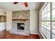 Brick fireplace with a wood mantel and large window at 3202 Misty Morn Ct, St Cloud, FL 34771