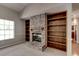 Brick fireplace with built-in shelving on either side at 3202 Misty Morn Ct, St Cloud, FL 34771