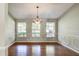 Formal dining room with hardwood floors, chandelier, and wainscoting at 3202 Misty Morn Ct, St Cloud, FL 34771