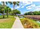 Peaceful waterfront view with a walkway and covered dock at 3202 Misty Morn Ct, St Cloud, FL 34771