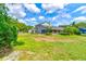 Large grassy backyard behind a two-story home at 3202 Misty Morn Ct, St Cloud, FL 34771