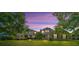 Beautiful home exterior at sunset with lush landscaping at 3202 Misty Morn Ct, St Cloud, FL 34771