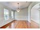 Formal dining room with hardwood floors, chandelier, and wainscoting at 3202 Misty Morn Ct, St Cloud, FL 34771