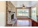 Brick fireplace with a wood mantel and large window view at 3202 Misty Morn Ct, St Cloud, FL 34771