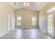 Bright Gathering room with vaulted ceiling, wood-look floors, and sliding glass doors at 3202 Misty Morn Ct, St Cloud, FL 34771