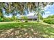 Home with lush landscaping and large oak tree at 3202 Misty Morn Ct, St Cloud, FL 34771