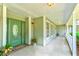 Spacious front porch with green door and white railings at 3202 Misty Morn Ct, St Cloud, FL 34771