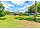 Large backyard with a view of the house and surrounding trees at 3202 Misty Morn Ct, St Cloud, FL 34771