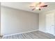 Simple bedroom with ceiling fan and wood-look floors at 3202 Misty Morn Ct, St Cloud, FL 34771