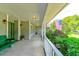 Front porch with green swing and American flag at 3202 Misty Morn Ct, St Cloud, FL 34771