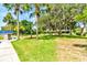 Large backyard with mature trees and partial view of home at 3202 Misty Morn Ct, St Cloud, FL 34771
