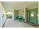 Relaxing front porch with green swing and potted plants at 3202 Misty Morn Ct, St Cloud, FL 34771