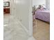 Bedroom with hardwood floors and view into bathroom at 9226 Longfellow Pl, Apopka, FL 32703
