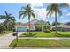 Single-Gathering home with light blue accents and a well-manicured lawn at 9226 Longfellow Pl, Apopka, FL 32703