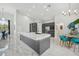 Modern kitchen with large island, stainless steel appliances and white quartz countertops at 9226 Longfellow Pl, Apopka, FL 32703