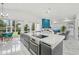 Modern kitchen with large island, stainless steel appliances and white quartz countertops at 9226 Longfellow Pl, Apopka, FL 32703