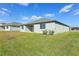Private backyard with covered patio and grassy area at 2012 Rosewood Dr, Bartow, FL 33830