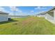 Spacious backyard with pond view and grassy area at 2012 Rosewood Dr, Bartow, FL 33830