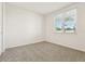 Simple bedroom with grey carpet and window at 2012 Rosewood Dr, Bartow, FL 33830