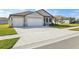 Two-car garage and a large driveway, light grey exterior at 2012 Rosewood Dr, Bartow, FL 33830