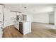 Open kitchen with white cabinets, island, and stainless steel appliances at 2012 Rosewood Dr, Bartow, FL 33830