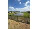 Tranquil pond view from backyard, featuring a black metal fence at 2927 Camden Way, Davenport, FL 33837