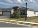 Modern home with stone accents and a palm tree at 2927 Camden Way, Davenport, FL 33837