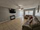 Spacious living room featuring a large TV, sectional sofa, and tile flooring at 5434 River Rock Rd, Lakeland, FL 33809