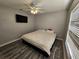 Bright bedroom featuring a king-size bed and a wall-mounted TV at 5434 River Rock Rd, Lakeland, FL 33809