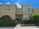 Two-story townhome with light yellow exterior and a welcoming porch at 5434 River Rock Rd, Lakeland, FL 33809