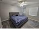 Spacious bedroom with ceiling fan, wood-look floors, and king-size bed at 5434 River Rock Rd, Lakeland, FL 33809