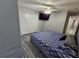 Bedroom with king bed, ceiling fan, and double doors to closet at 5434 River Rock Rd, Lakeland, FL 33809