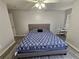 King bedroom with ceiling fan, wood-look floors, and a small desk at 5434 River Rock Rd, Lakeland, FL 33809