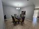 Dining room with a glass-top table, six chairs, and a chandelier at 5434 River Rock Rd, Lakeland, FL 33809