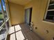 Screened porch with access to the backyard and tile floor at 5434 River Rock Rd, Lakeland, FL 33809