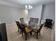 Dining room with a glass-top table, six chairs, and a chandelier at 5434 River Rock Rd, Lakeland, FL 33809