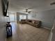 Bright living room with a large sectional sofa and tile floors at 5434 River Rock Rd, Lakeland, FL 33809