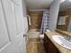 Bathroom with tub, shower, and dark brown vanity at 5434 River Rock Rd, Lakeland, FL 33809